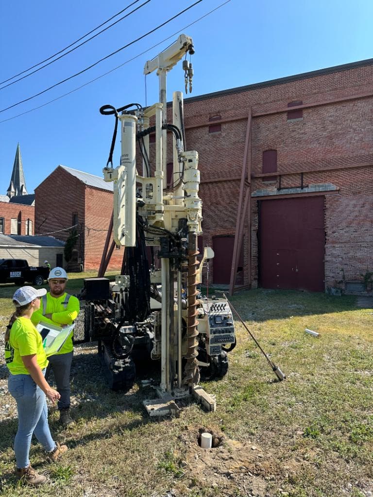 Geoprobe drill rig conducting site assessment at a historic brick building