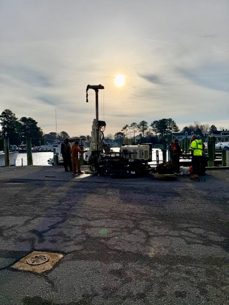 Subsurface investigation with drill rig at a marina dock at sunset