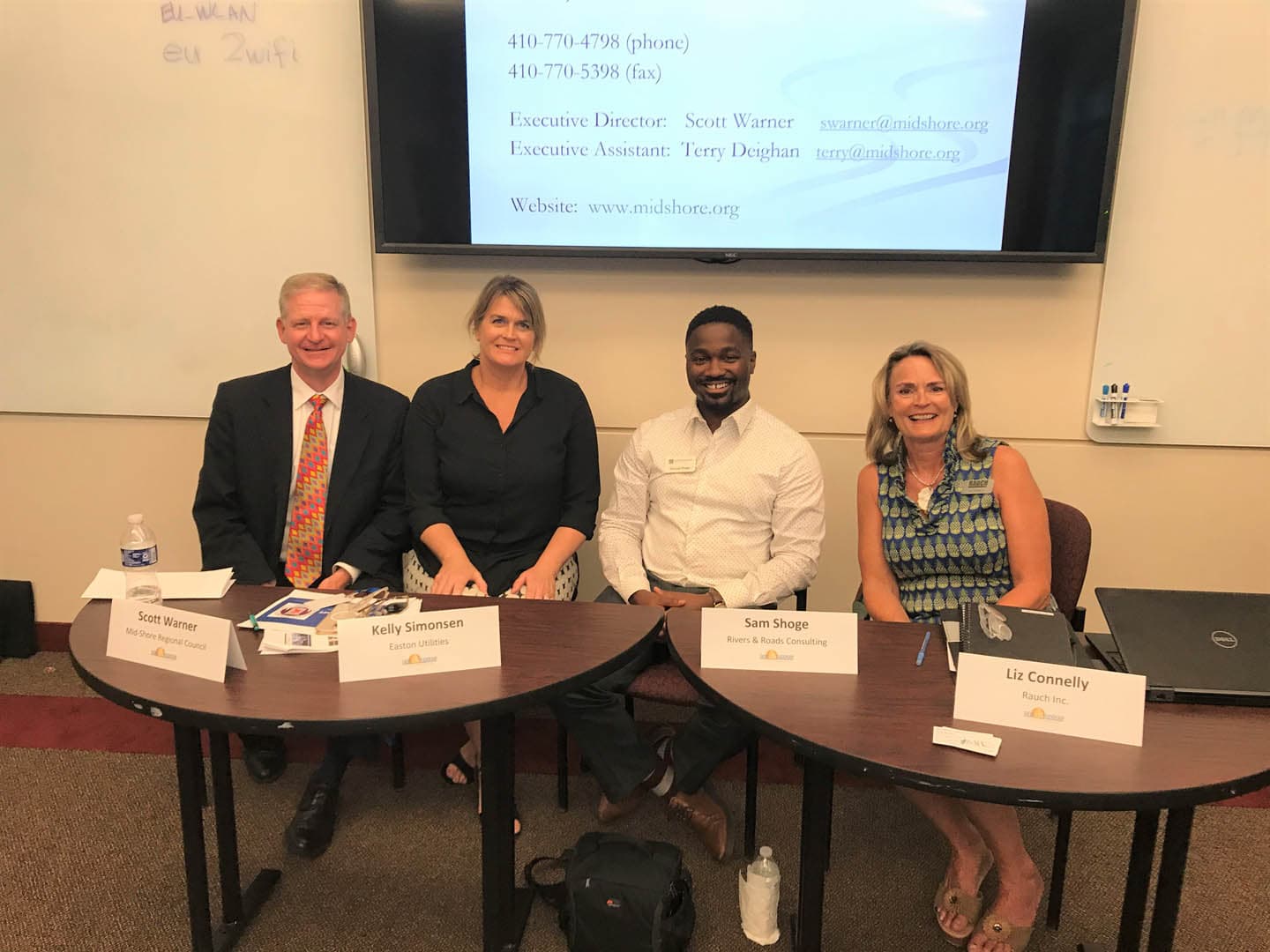 Four panelists seated at a table during a Mid-Shore Regional Council meeting, including representatives from Easton Utilities and RAUCH Inc.