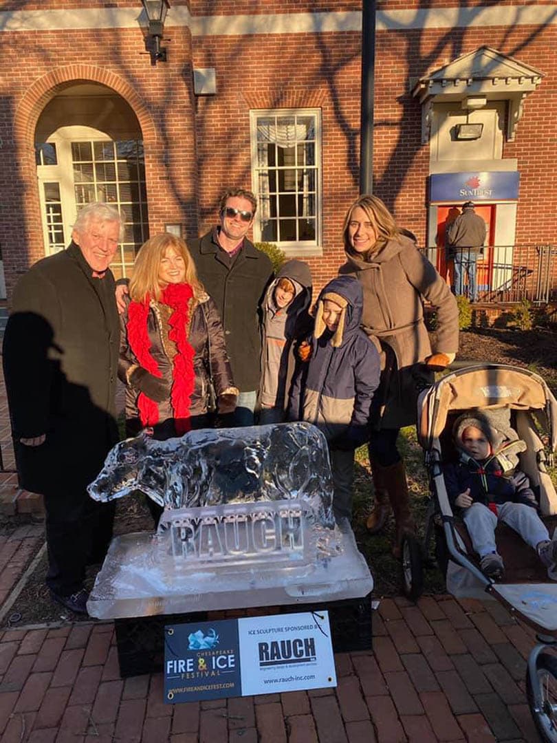 RAUCH Inc. staff and family pose with a sponsored RAUCH-branded ice sculpture bear at the Chesapeake Fire and Ice Festival