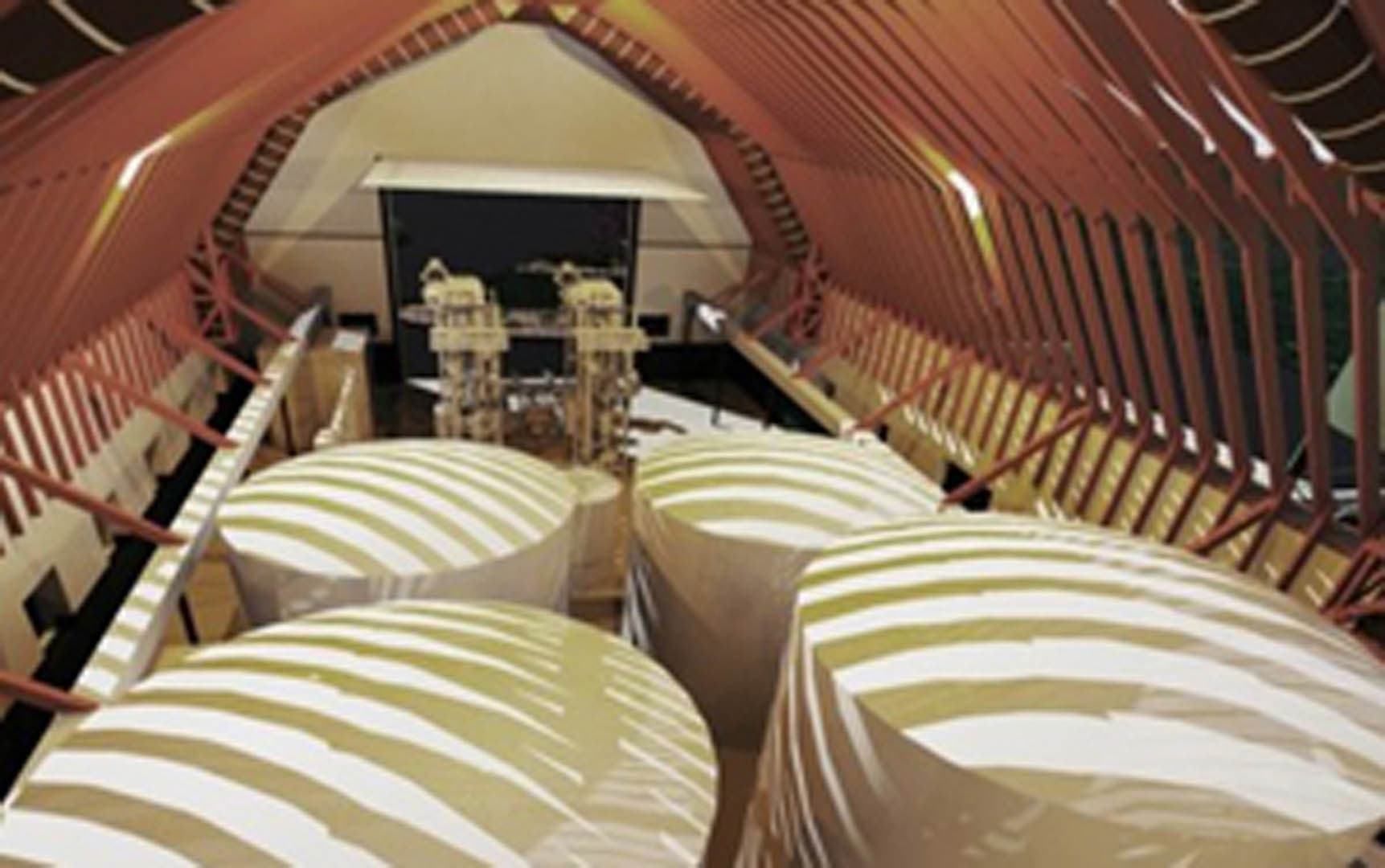 3D rendering of the interior of a water treatment plant showing multiple large storage tanks, stairways, and mechanical process equipment